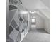 Hallway featuring modern decorative wall, carpeted floor, and access to multiple rooms at 12383 S 25 W, Columbus, IN 47201