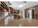 Bright kitchen with granite countertops, wooden cabinets, stainless steel fridge, and wood-look flooring at 12383 S 25 W, Columbus, IN 47201