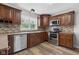 Well-equipped kitchen with stainless steel appliances, granite counters, wood cabinets, and stylish backsplash at 12383 S 25 W, Columbus, IN 47201