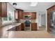 Bright kitchen with granite countertops, wood cabinets, stainless steel appliances, mosaic backsplash, and hardwood floors at 12383 S 25 W, Columbus, IN 47201