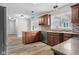 Kitchen with wood cabinets, stainless steel appliances, granite counters, stylish backsplash, and hardwood style floors at 12383 S 25 W, Columbus, IN 47201