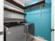 Laundry room featuring a modern washer and dryer and attractive storage shelves at 12383 S 25 W, Columbus, IN 47201
