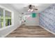 Bright living room featuring hardwood floors, neutral colors, updated ceiling fan, and decorative wall at 12383 S 25 W, Columbus, IN 47201