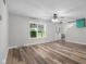 Bright living room with hardwood floors, large window with backyard view, and neutral paint colors at 12383 S 25 W, Columbus, IN 47201