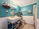 Bright bathroom features turquoise walls, a modern sink, and stylish decor at 12508 N Jackley Rd, Elwood, IN 46036