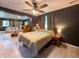 Cozy bedroom featuring a ceiling fan, neutral decor, and ample natural light at 12508 N Jackley Rd, Elwood, IN 46036