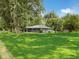 Traditional ranch style home with gray siding, mature trees, green yard, and a welcoming front porch at 12508 N Jackley Rd, Elwood, IN 46036
