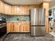 Modern kitchen with stainless steel refrigerator and wood cabinets at 12508 N Jackley Rd, Elwood, IN 46036