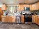 Updated kitchen with stainless steel appliances, tile backsplash, and wood cabinets at 12508 N Jackley Rd, Elwood, IN 46036