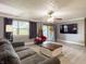 Comfortable living room with gray sofa, ceiling fan, wood look flooring and a view of the front yard at 12508 N Jackley Rd, Elwood, IN 46036