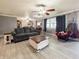 Bright living room with gray walls, updated flooring, and a decorative ceiling fan at 12508 N Jackley Rd, Elwood, IN 46036