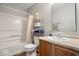 Bright bathroom with a shower-tub combo, shelving unit for storage, and updated sink vanity at 12624 Majestic Way, Fishers, IN 46037