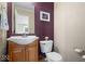 This half bathroom features a decorative sink, and a purple accent wall at 12624 Majestic Way, Fishers, IN 46037