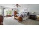 The primary bedroom is spacious and bright, featuring a ceiling fan and a large window at 12624 Majestic Way, Fishers, IN 46037