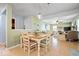 The dining area has a light fixture over the table and access to a living room at 12624 Majestic Way, Fishers, IN 46037