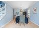 Formal dining room with hardwood floors, blue accent walls, and staircase access at 12624 Majestic Way, Fishers, IN 46037