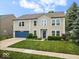 Charming two-story home featuring a blue garage door, well-maintained lawn, and manicured landscaping at 12624 Majestic Way, Fishers, IN 46037
