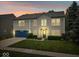 Charming two-story home featuring a blue garage door, well-maintained lawn, and manicured landscaping at 12624 Majestic Way, Fishers, IN 46037