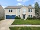 Charming two-story home featuring a blue garage door, well-maintained lawn, and manicured landscaping at 12624 Majestic Way, Fishers, IN 46037