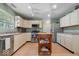 This kitchen is painted a lovely green and features wood floors and stainless steel appliances at 12624 Majestic Way, Fishers, IN 46037