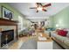 Open living room featuring a fireplace, ceiling fan, hardwood floors and access to the kitchen at 12624 Majestic Way, Fishers, IN 46037