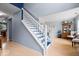 Inviting foyer with a staircase featuring blue accents and light hardwood flooring at 12624 Majestic Way, Fishers, IN 46037
