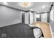 A bedroom featuring wood-look floors, a patterned ceiling light, and a comfortable bed with gray bedding at 1331 N Berwick Ave, Indianapolis, IN 46222