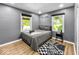 Bedroom with gray walls, hardwood flooring, with two windows at 1331 N Berwick Ave, Indianapolis, IN 46222