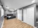 A spacious bedroom features wood-look flooring, white closet doors, and a comfortable bed with gray bedding at 1331 N Berwick Ave, Indianapolis, IN 46222