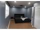 This bedroom features hardwood floors, a black bedset, and natural lighting at 1331 N Berwick Ave, Indianapolis, IN 46222