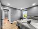 This bedroom features gray walls, wood flooring, a window, and a neatly made bed with gray bedding at 1331 N Berwick Ave, Indianapolis, IN 46222