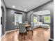 Inviting dining room with hardwood floors, neutral gray walls, and ample natural light connecting to the living room at 1331 N Berwick Ave, Indianapolis, IN 46222
