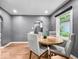 Well-lit dining area featuring hardwood floors, seating for four, and an archway leading into the adjacent kitchen at 1331 N Berwick Ave, Indianapolis, IN 46222