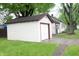 A single-story house with a detached one-car garage, a well-maintained lawn, and mature trees at 1331 N Berwick Ave, Indianapolis, IN 46222