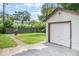 Garage and yard showing a grassy area with a partial view of the house over a wooden fence at 1331 N Berwick Ave, Indianapolis, IN 46222