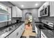 Galley kitchen features white cabinets, black hardware and a modern look at 1331 N Berwick Ave, Indianapolis, IN 46222