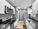 Modern kitchen featuring stainless steel appliances, granite countertops, and white cabinetry, ideal for cooking and entertaining at 1331 N Berwick Ave, Indianapolis, IN 46222