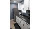 Well-lit kitchen features gray walls, granite countertops, stainless steel appliances, and a refrigerator at 1331 N Berwick Ave, Indianapolis, IN 46222