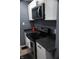 Kitchen featuring black appliances, granite countertops, and bright white cabinets and stainless microwave at 1331 N Berwick Ave, Indianapolis, IN 46222