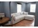 Bright living room with hardwood floors and a comfortable sectional couch and view into dining area at 1331 N Berwick Ave, Indianapolis, IN 46222