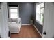 Inviting living room boasts hardwood flooring, a comfortable couch, and natural light at 1331 N Berwick Ave, Indianapolis, IN 46222