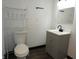 Updated bathroom with a vanity and cabinet plus a toilet with shelving at 1352 W 22Nd St, Indianapolis, IN 46202