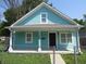 Charming exterior view of a light blue home with white trim and a welcoming front porch at 1352 W 22Nd St, Indianapolis, IN 46202
