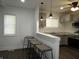 Kitchen bar area, featuring barstool seating with a view of the updated kitchen at 1352 W 22Nd St, Indianapolis, IN 46202