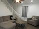 Cozy living room featuring comfortable seating, a ceiling fan, and stylish hardwood flooring at 1352 W 22Nd St, Indianapolis, IN 46202