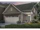 Charming home featuring a stone facade, attached two-car garage, and well-manicured lawn at 14878 E Keenan Cir # Lot 37, Westfield, IN 46074