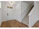 Inviting foyer features wood flooring, a staircase with carpet runner, and a front door at 14878 E Keenan Cir # Lot 37, Westfield, IN 46074