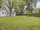 Expansive backyard offers a large lawn and a wooden fence, providing a serene outdoor setting at 1617 E 52Nd St, Indianapolis, IN 46205