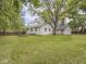 A well-maintained backyard features a detached garage and mature trees, perfect for outdoor enjoyment at 1617 E 52Nd St, Indianapolis, IN 46205
