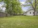 Spacious backyard with mature trees and a wooden fence offers a private outdoor space at 1617 E 52Nd St, Indianapolis, IN 46205